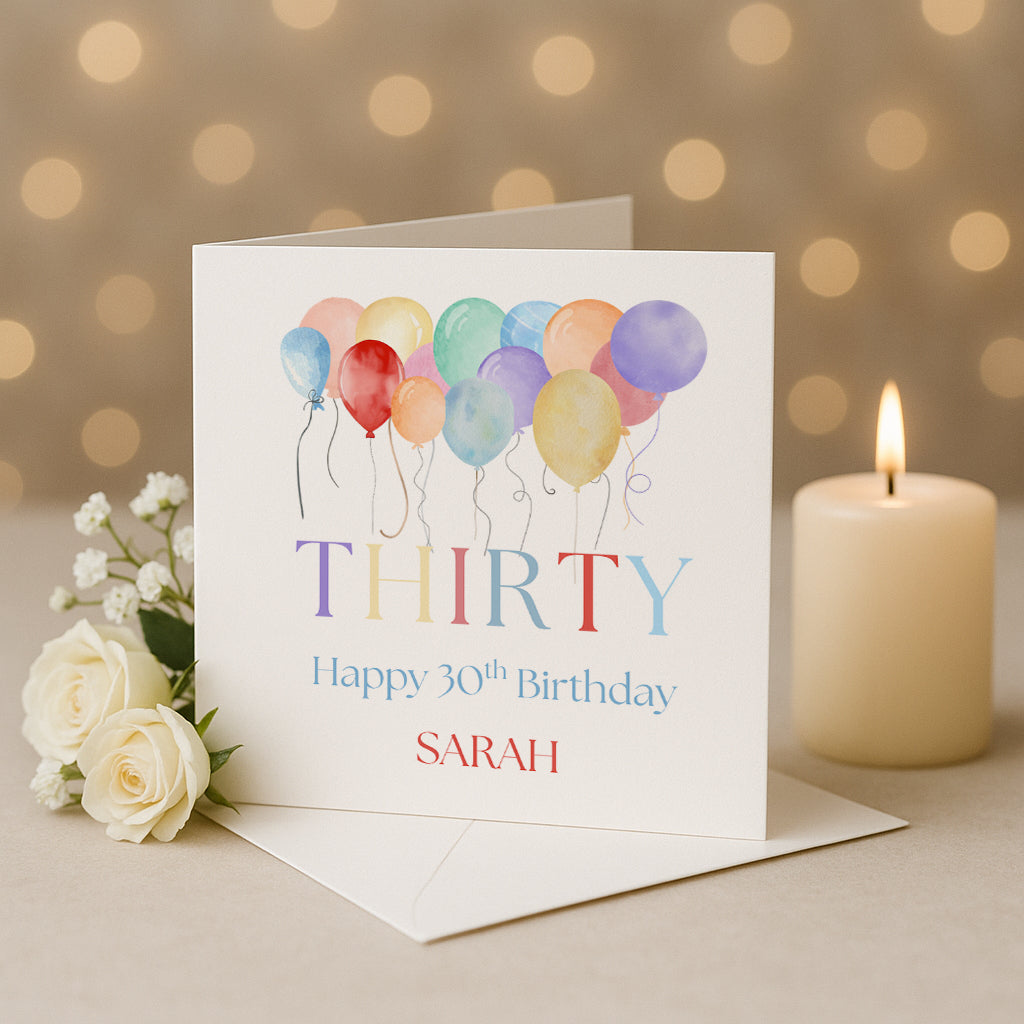 Happy 30th birthday card with colorful balloons, a candle, and flowers on a warm background.