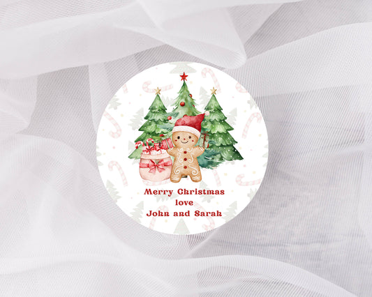 Round Christmas sticker with gingerbread men and trees on a white background