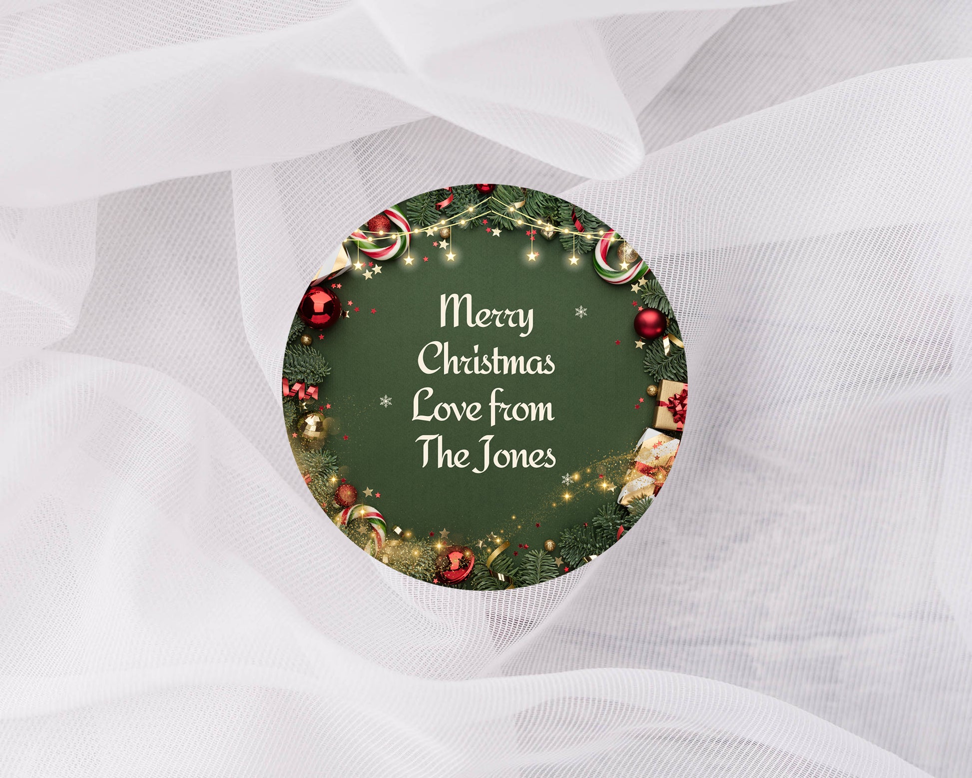 Round Christmas ornament with decorative text on a white fabric background