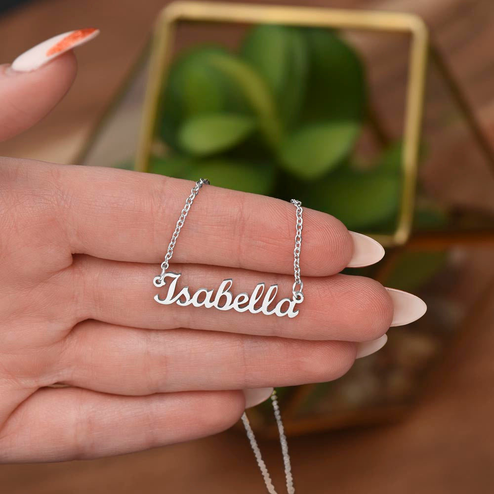 Name Necklace held in a hand and is silver design