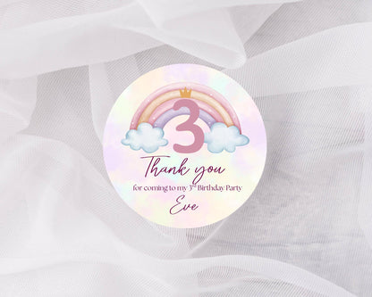 Round sticker with rainbow, number 3, and cloud design on a white background