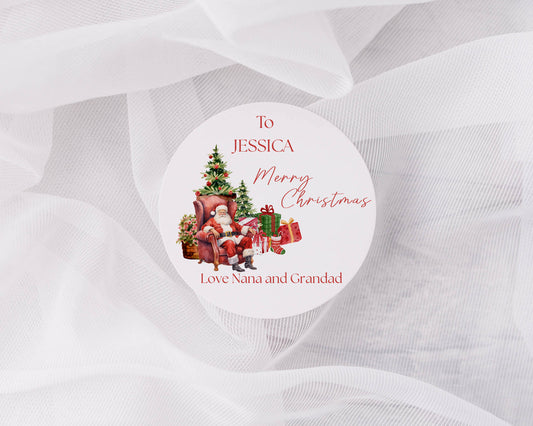 Personalized Christmas sticker with Santa Claus, trees, and presents on a white background.